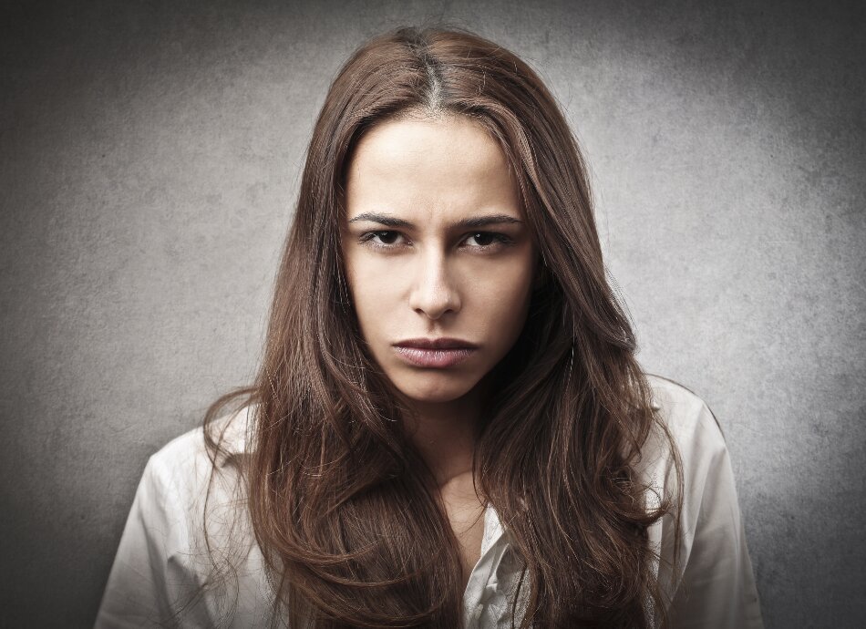 Young woman looking defiant canva 950x690