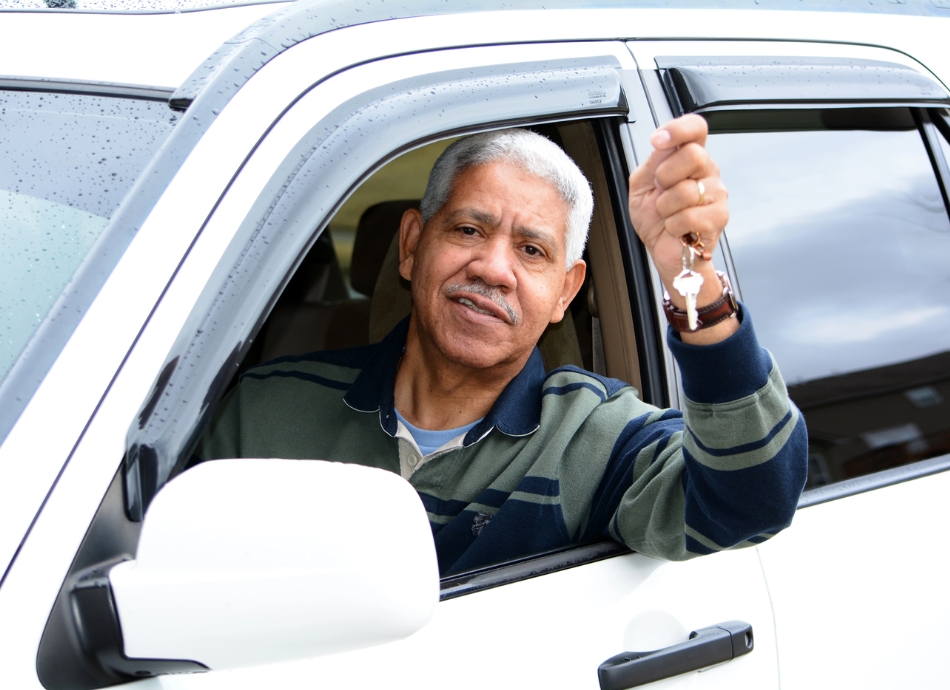 Man sitting in car holding car keys