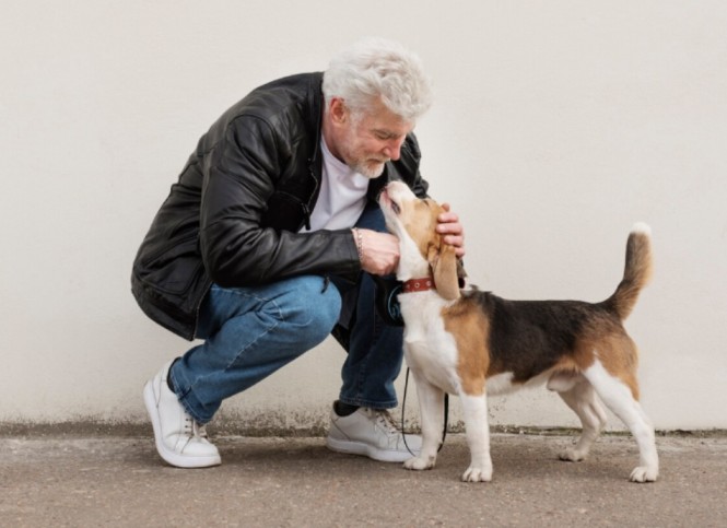 Man bending down and patting his dog