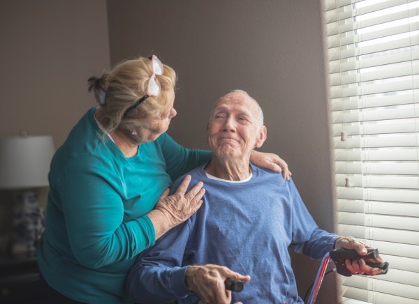Older man smiling at caregiver