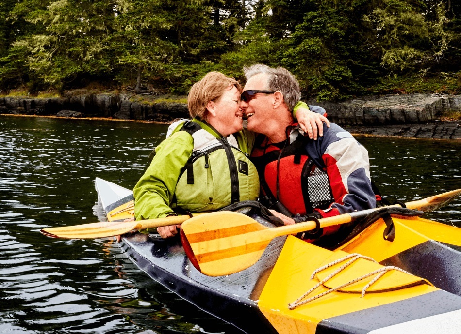 Senior couple kayaking and kissing