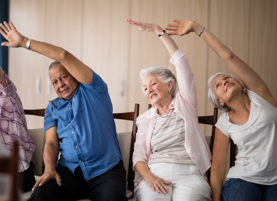 Seniors do chair-based exercises and stretches
