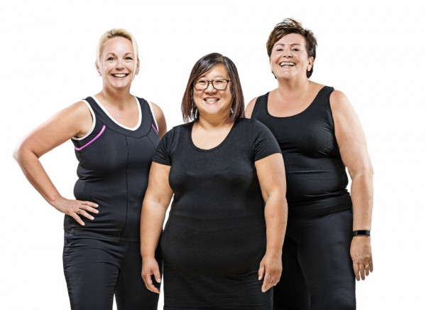 3 smiling middle-aged women in exercise clothing