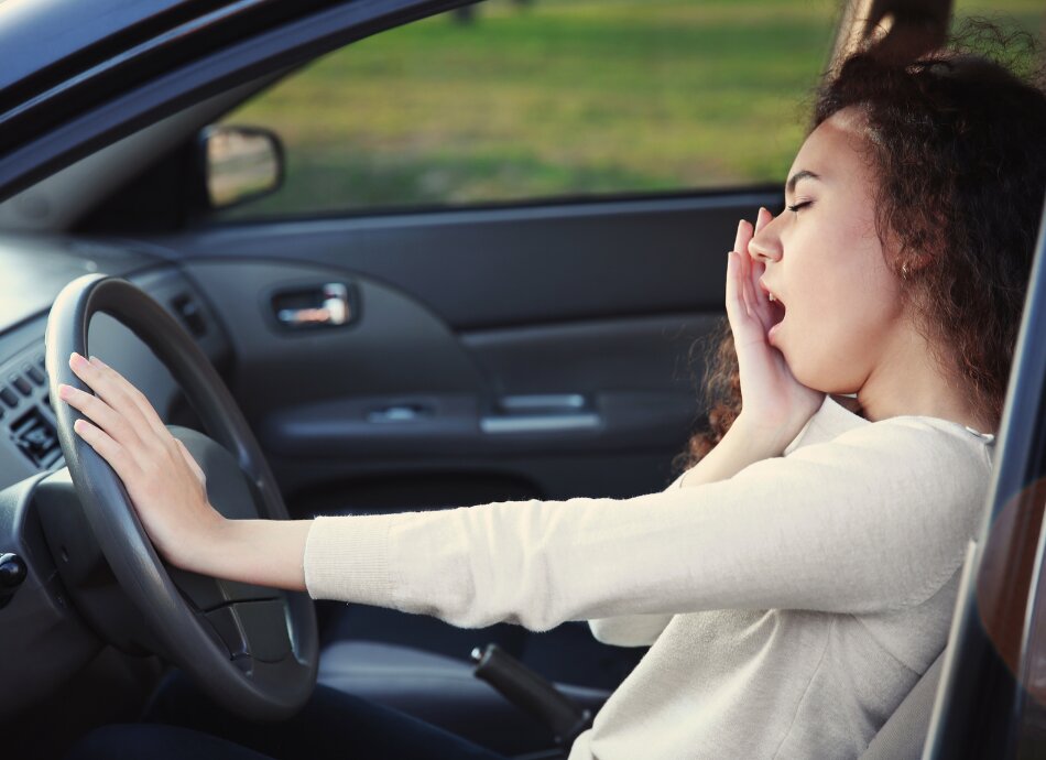 Woman yawning in car