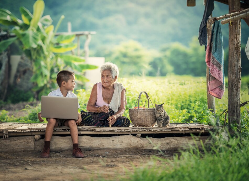 Boy with grandmother and laptop Myanmar
