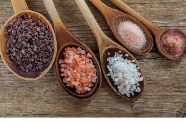 Variety of different salts on wooden spoons