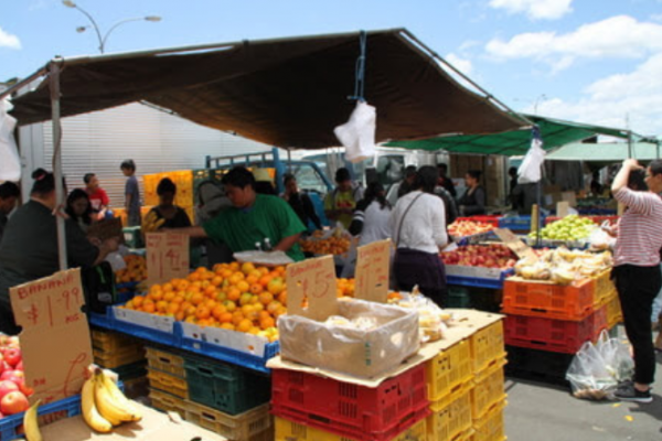 Outdoor market stalls with people and fresh food, New Zealand