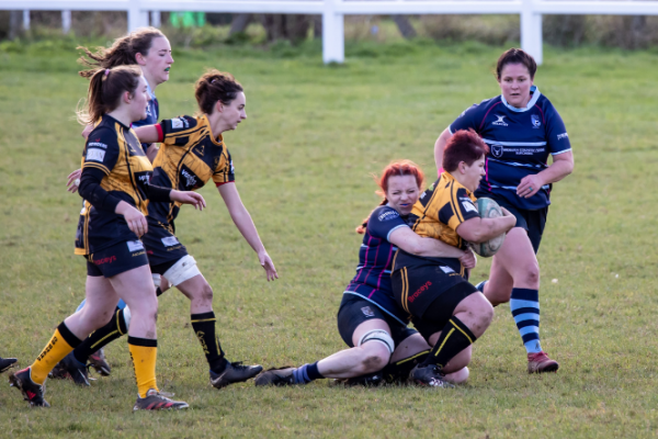 Women playing rugby game