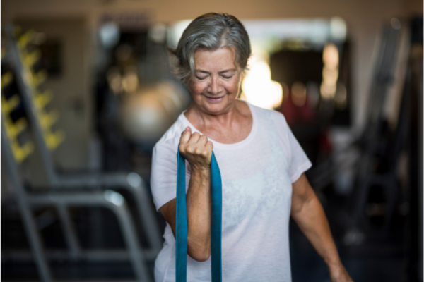 Older woman using stretchy bands for exercise