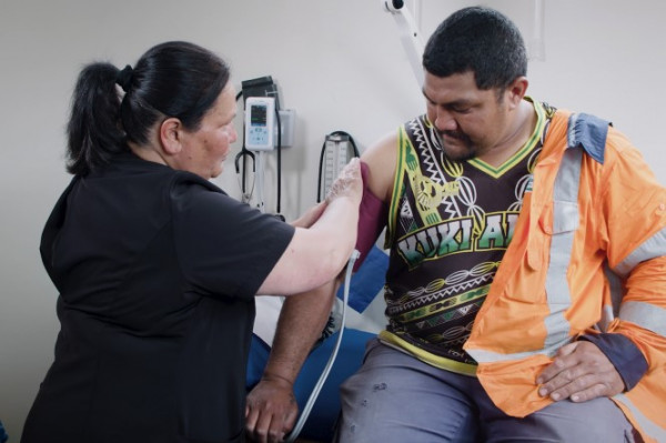Maori man having blood pressure taken by nurse