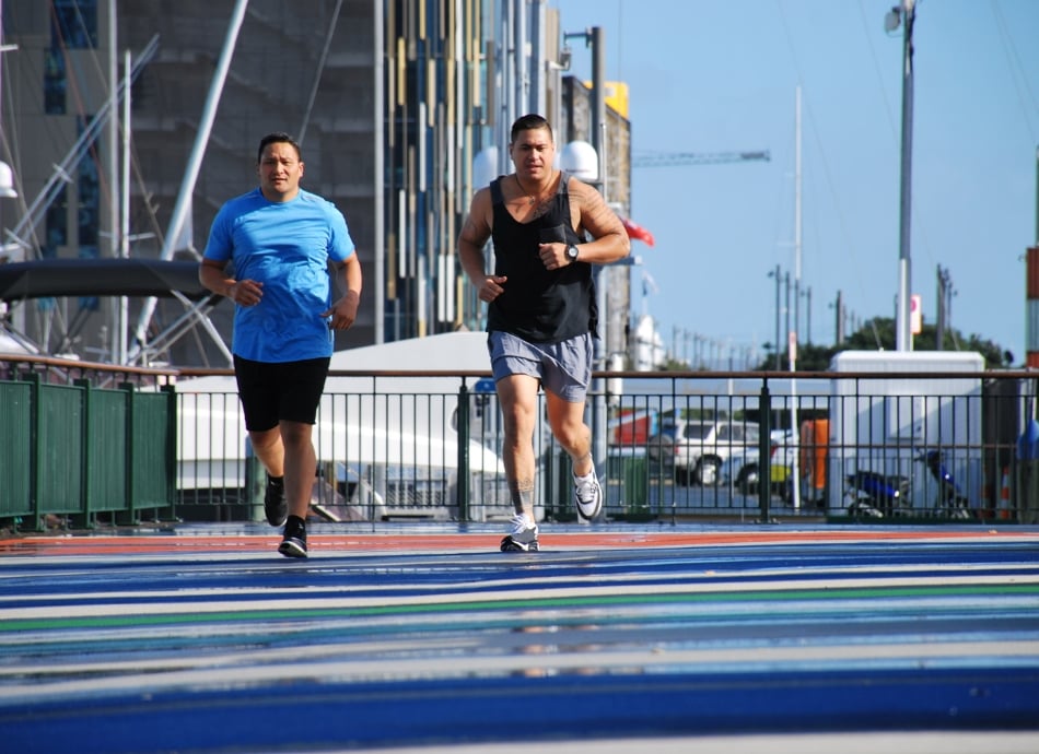 Two men jogging by waterfront in Auckland city