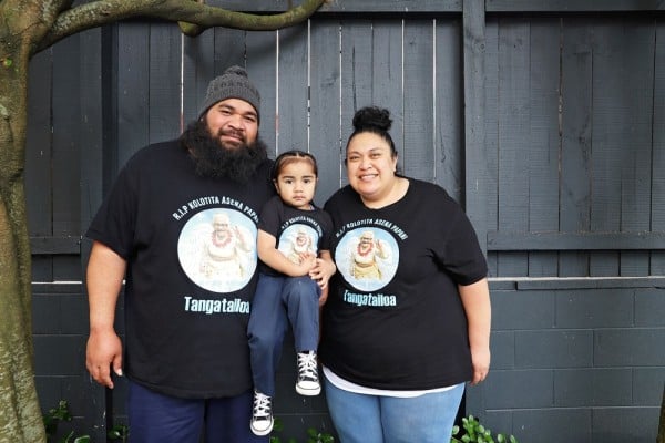 Smiling Pasifika couple with young child