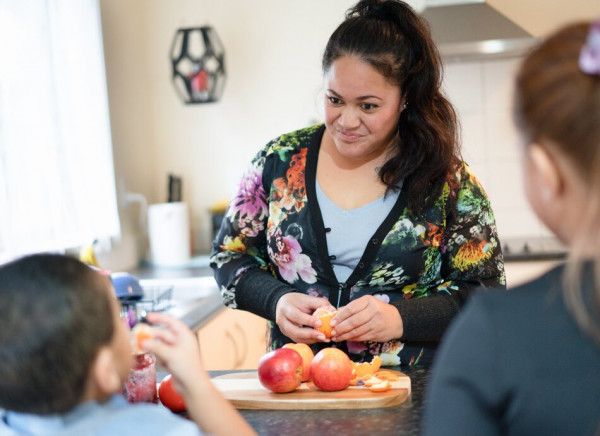 Young Māori wahine preparing fruit for her tamariki