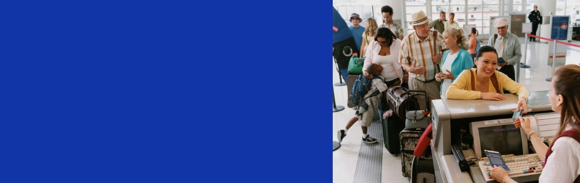 People queue at airport check in counter slider