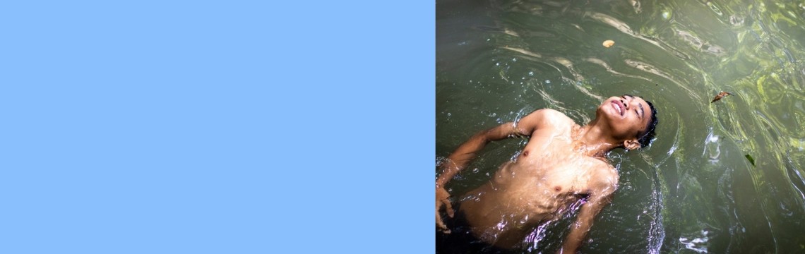 Boy floats in river water