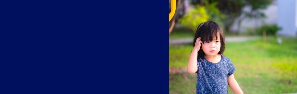 Little girl with itchy head in playground slider