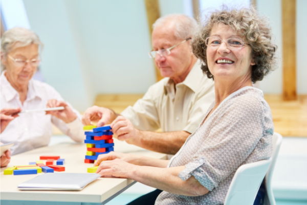 Older people siting at a table with building blocks