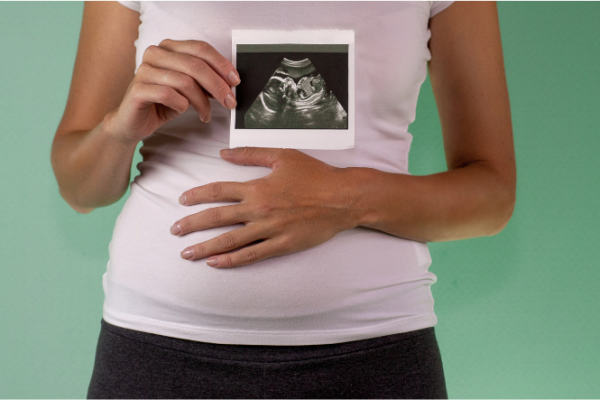 Pregnant woman with ultrasound image